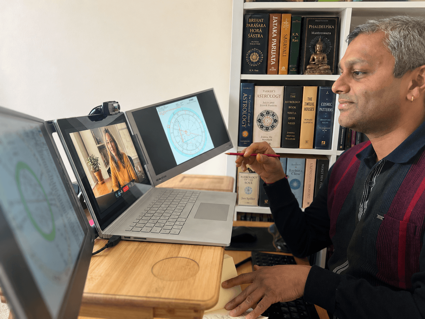Amit conducting a live astrology consultation with charts and books